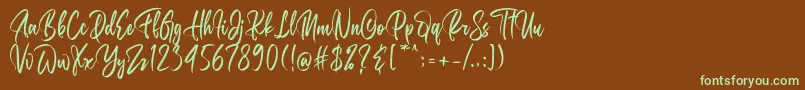 フォントBelgedes – 緑色の文字が茶色の背景にあります。