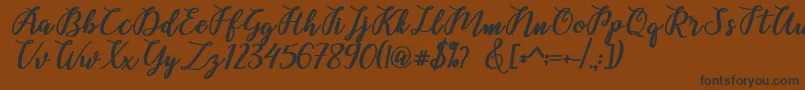 Belinda Script Font – Black Fonts on Brown Background