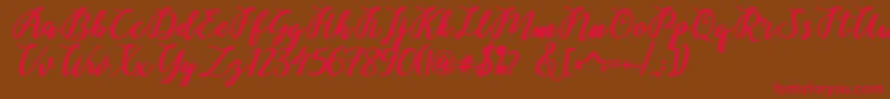 フォントBelinda Script – 赤い文字が茶色の背景にあります。
