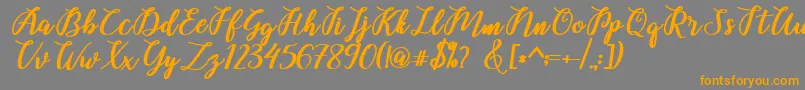 Belinda Script-Schriftart – Orangefarbene Schriften auf grauem Hintergrund