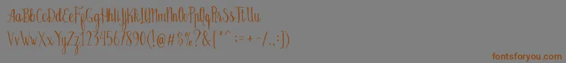 Bellanie Script Free Demo-Schriftart – Braune Schriften auf grauem Hintergrund
