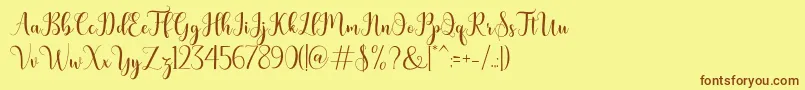 フォントbertilda – 茶色の文字が黄色の背景にあります。