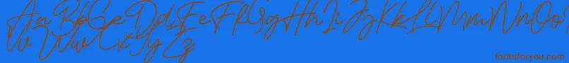 Fonte Bessita Handwriting Free – fontes marrons em um fundo azul