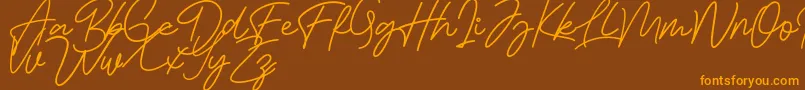 Bessita Handwriting Free Font – Orange Fonts on Brown Background