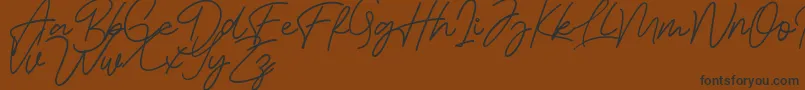 Bessita Handwriting Free Font – Black Fonts on Brown Background
