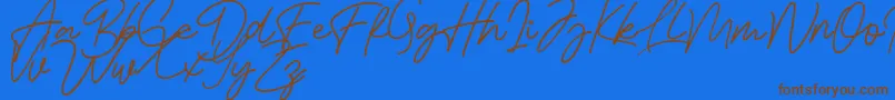 Bessita Handwriting Free Font – Brown Fonts on Blue Background