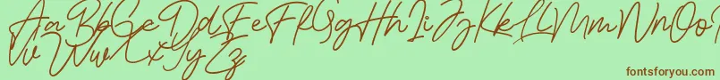 Bessita Handwriting Free Font – Brown Fonts on Green Background