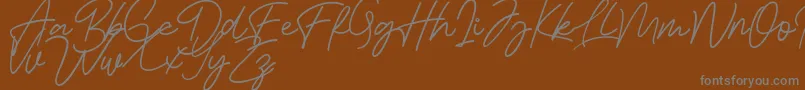 Bessita Handwriting Free Font – Gray Fonts on Brown Background