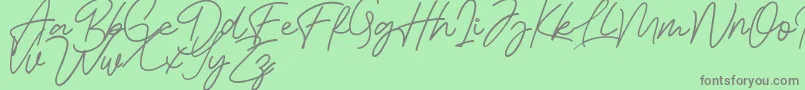 Bessita Handwriting Free Font – Gray Fonts on Green Background