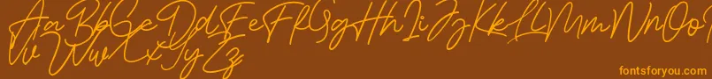 Bessita Handwriting Free Font – Orange Fonts on Brown Background