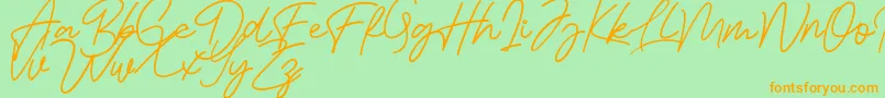 Bessita Handwriting Free-Schriftart – Orangefarbene Schriften auf grünem Hintergrund