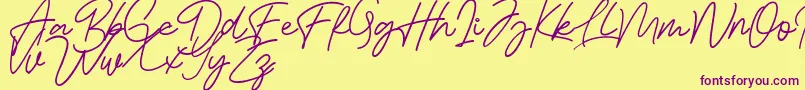 Czcionka Bessita Handwriting Free – fioletowe czcionki na żółtym tle