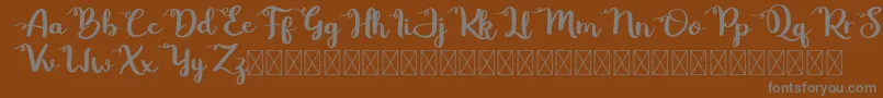 Betty Rose-fontti – harmaat kirjasimet ruskealla taustalla