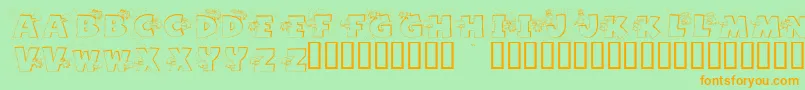 フォントGrazingOnGrass – オレンジの文字が緑の背景にあります。