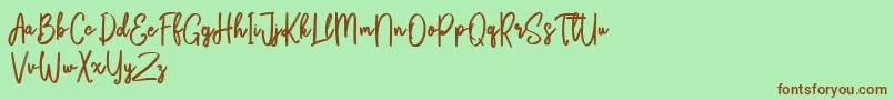 Fonte Bikarosta Script – fontes marrons em um fundo verde