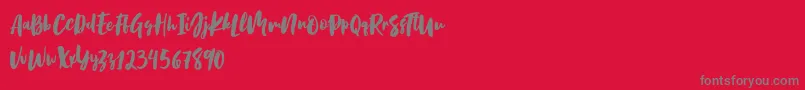 Birabella Script-fontti – harmaat kirjasimet punaisella taustalla