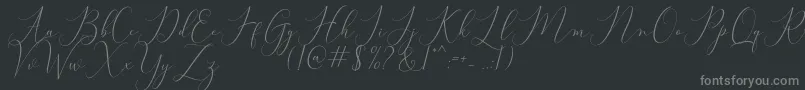 Bitthai Script-fontti – harmaat kirjasimet mustalla taustalla