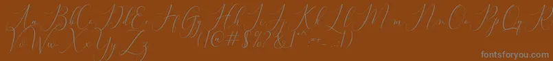 Bitthai Script-Schriftart – Graue Schriften auf braunem Hintergrund