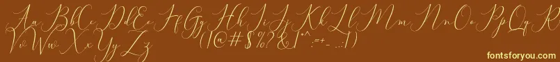 Bitthai Script-fontti – keltaiset fontit ruskealla taustalla