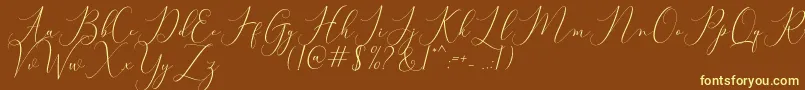 Bitthai Script-Schriftart – Gelbe Schriften auf braunem Hintergrund