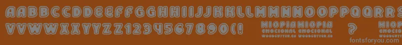 フォントMiopiaEmocional – 茶色の背景に灰色の文字