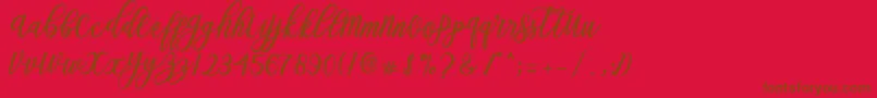 Blessed Script Font – Brown Fonts on Red Background