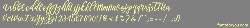 Blessed Script-Schriftart – Gelbe Schriften auf grauem Hintergrund