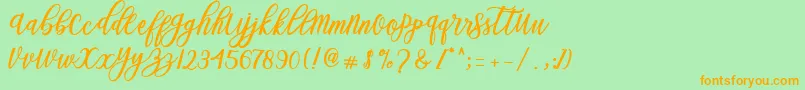 Blessed Script-Schriftart – Orangefarbene Schriften auf grünem Hintergrund