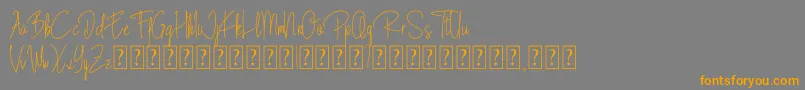 フォントBlista Rade – オレンジの文字は灰色の背景にあります。