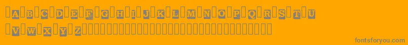 Fonte BlockLetters Demo Regular – fontes cinzas em um fundo laranja