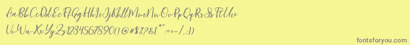 フォントBlondy Slant – 黄色の背景に灰色の文字