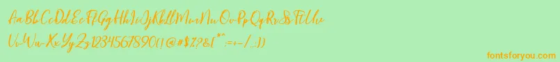 フォントBlondy Slant – オレンジの文字が緑の背景にあります。