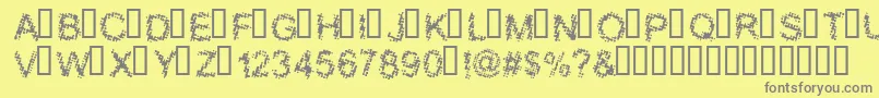 BLOOS   -fontti – harmaat kirjasimet keltaisella taustalla