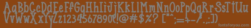 Blueno Chocolate  -Schriftart – Graue Schriften auf braunem Hintergrund