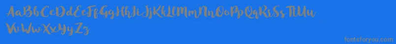 Blusty Script Free-Schriftart – Graue Schriften auf blauem Hintergrund