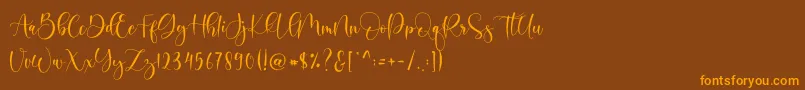 フォントBoshela – オレンジ色の文字が茶色の背景にあります。