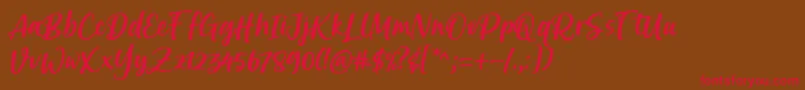 フォントBrastagi Font by 7NTypes – 赤い文字が茶色の背景にあります。