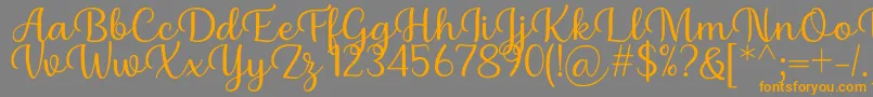 Шрифт Briany Font Regular by Andrian 7NTypes – оранжевые шрифты на сером фоне