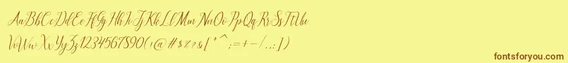 フォントbrillyo  reguler – 茶色の文字が黄色の背景にあります。