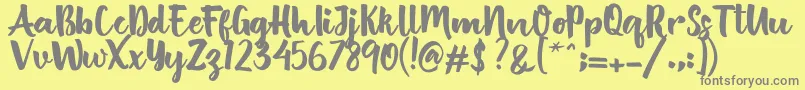 フォントBritish Script – 黄色の背景に灰色の文字