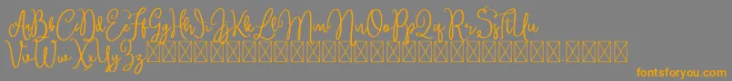 フォントBrittney – オレンジの文字は灰色の背景にあります。