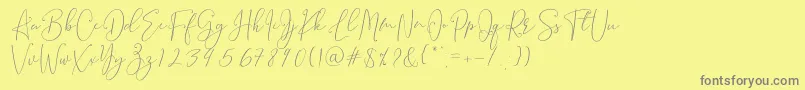 Brooke Smith Script-fontti – harmaat kirjasimet keltaisella taustalla