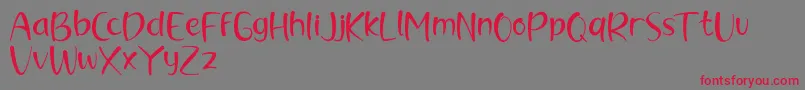 brush kencur demo Font – Red Fonts on Gray Background