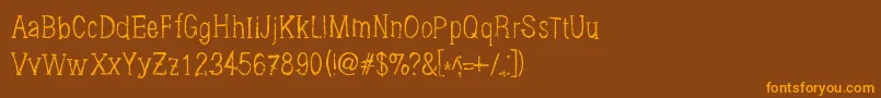 フォントBrushings – オレンジ色の文字が茶色の背景にあります。