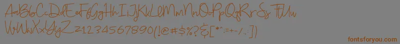 フォントBudayut – 茶色の文字が灰色の背景にあります。