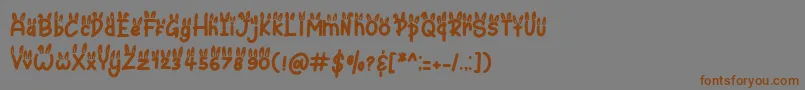 フォントBunny Ear – 茶色の文字が灰色の背景にあります。