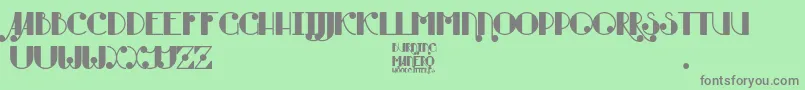 Burning Manero-fontti – harmaat kirjasimet vihreällä taustalla