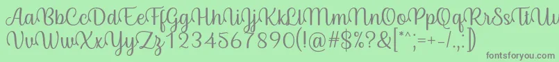 Fonte Byby Font Regular – fontes cinzas em um fundo verde