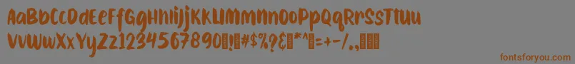 フォントCAIBOJOGRegular – 茶色の文字が灰色の背景にあります。