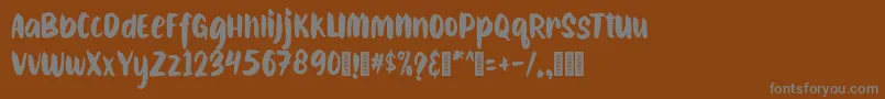 フォントCAIBOJOGRegular – 茶色の背景に灰色の文字